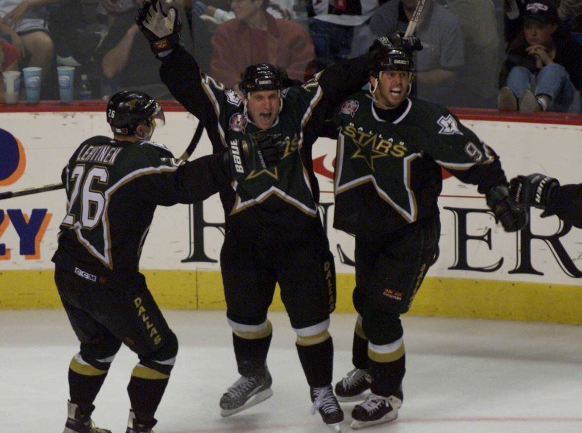 Stanley Cup Finals, Game 6 - The Stars' Jere Lehtinen and Mike Modano celebrate with Brett Hull (ctr) after Hull knocked in the winning shot during the 3rd OT of the 6th game of Stanley Cup Final at Marine Midland Arena in Buffalo.
