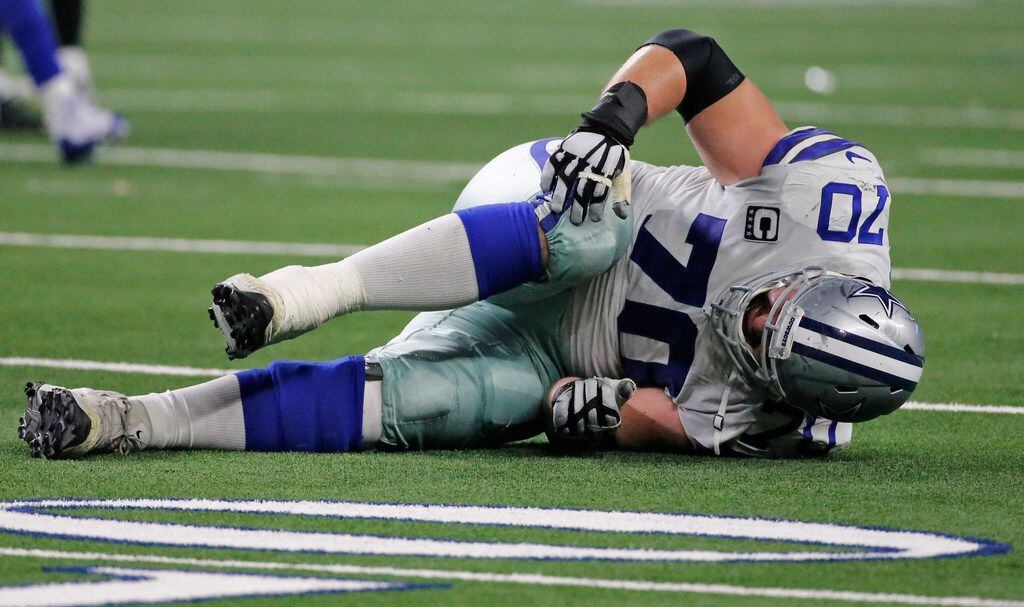 Dallas Cowboys offensive guard Zack Martin (70) hits the turf after getting hurt in the...