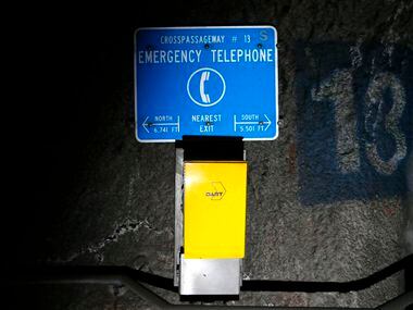 An emergency phone and directions to the nearest exit, seen inside DART's underground tunnel...