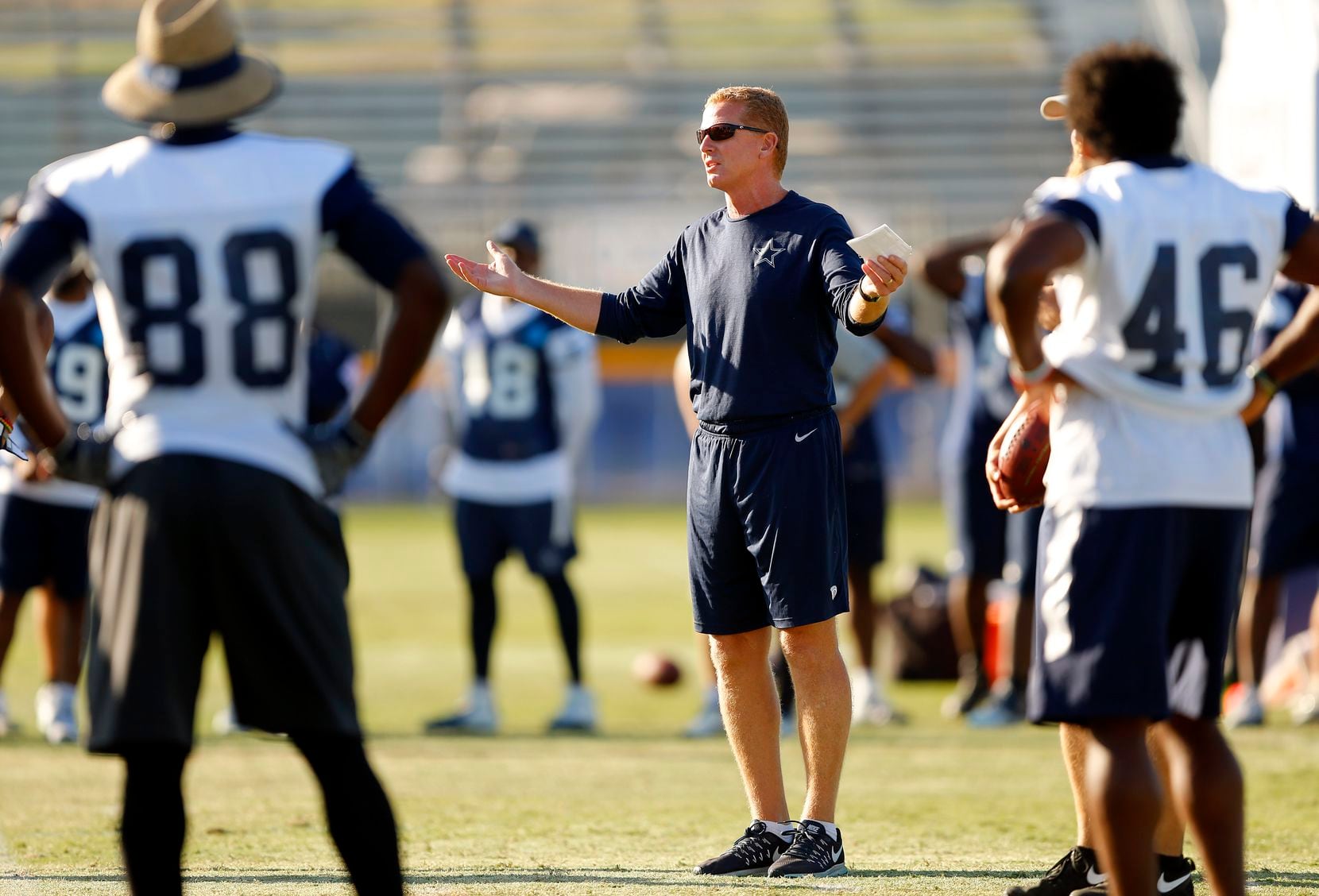 Dallas Cowboys head coach Jason Garrett instructs his players on last second plays during an...