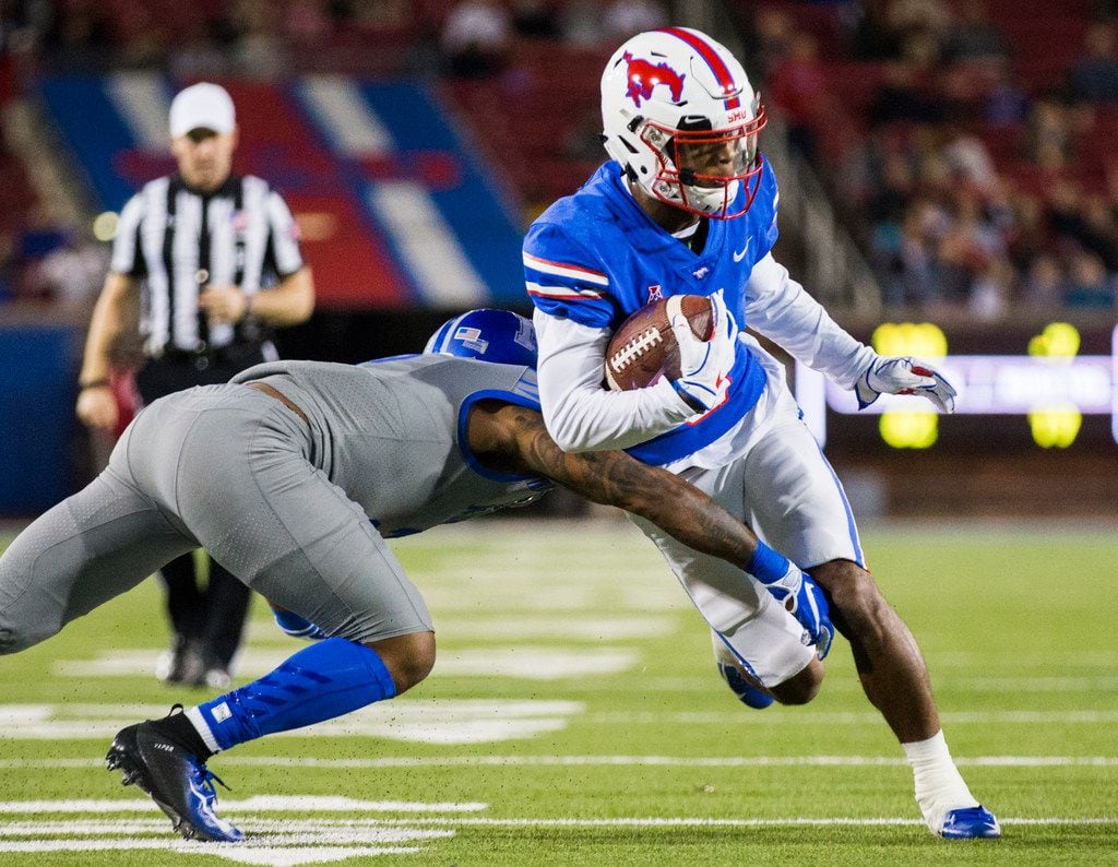 SMU Mustangs running back Braeden West (6) is tackled by Memphis Tigers defensive back T.J....