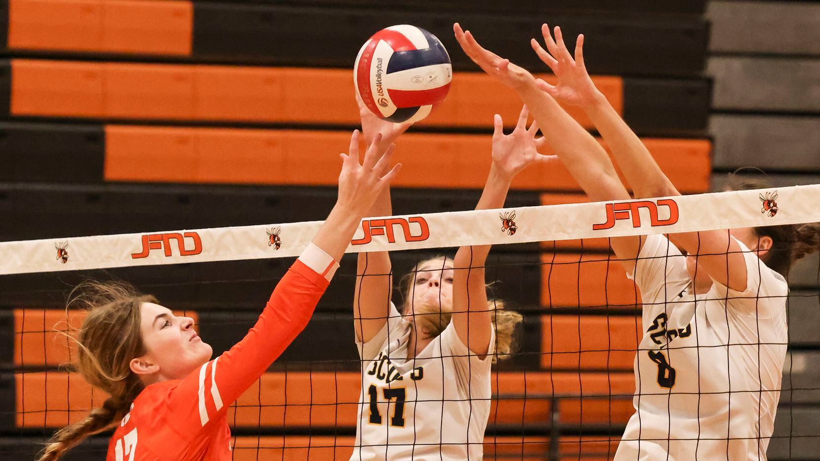 Rockwall's Sydney Lafferty (left) tries to spike the ball past the block of Highland Park’s...