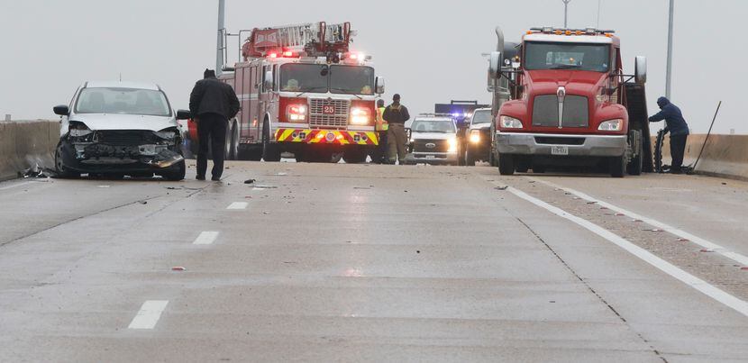 Dallas Police officers work an accident on southbound U.S. Highway 67 over Hampton Road on...