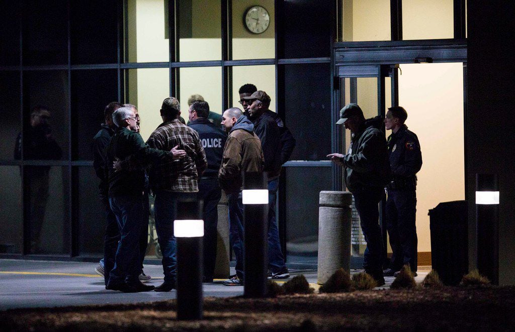 Police officers gather at the emergency room at Plano Medical City hospital after a...