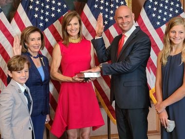 House Speaker Nancy Pelosi poses for a ceremonial swearing-in with Rep. Jake Ellzey on July 30, 2021, at the U.S. Capitol, three days after he defeated Trump-backed Susan Wright in a special election.  They're joined by his wife Shelby, holding a Bible, and their children McCall, 12, and Jack, 9. Wright's husband, Ron Wright, died in office in February, weeks after swearing in for a second term in the seat.