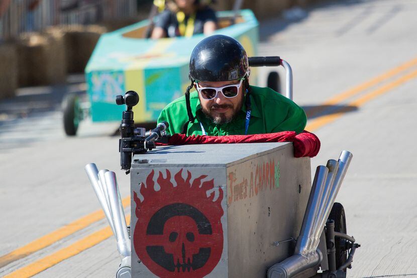 A racer goes down Hickory Street during the coffin race at Denton's Day of the Dead Festival.