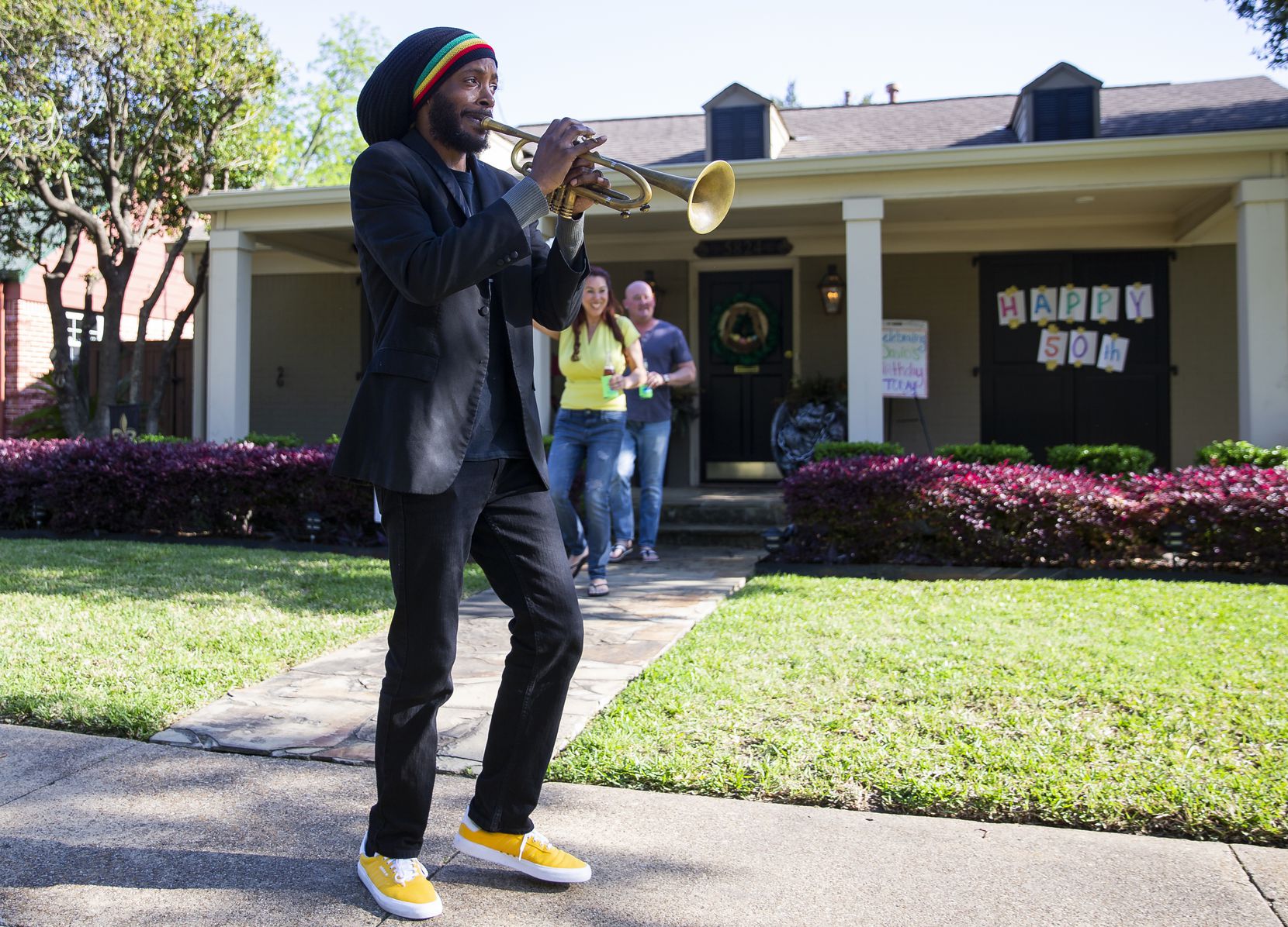 Trumpeter Alcedrick Todd (left) performs for David Hannah's 50th birthday outside of his house after his wife Dina Hannah posted on the Nextdoor app on April 10, 2020 in Dallas. The couple originally planned to celebrate the birthday in New Orleans. (Juan Figueroa/ The Dallas Morning News)