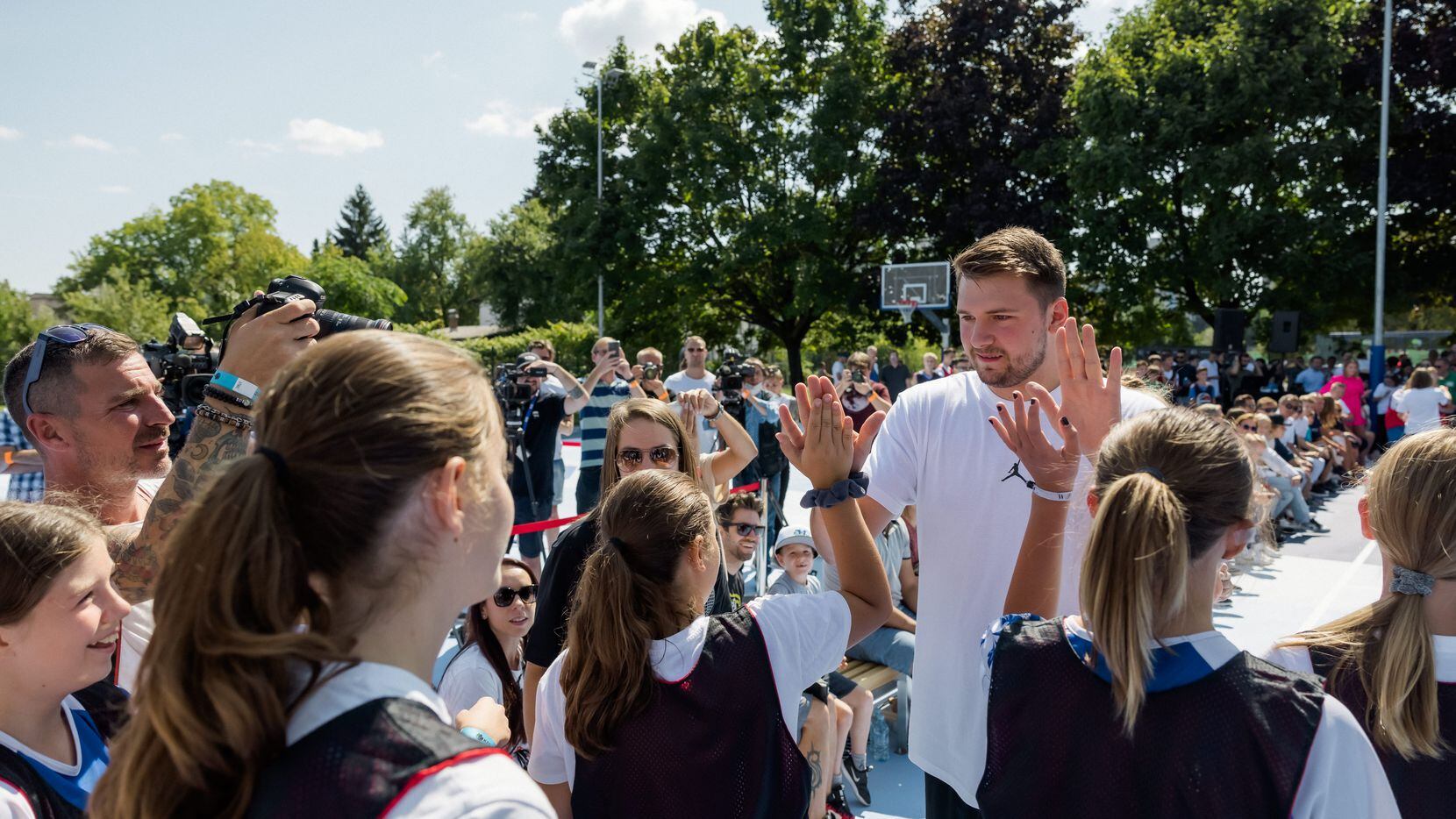 Luka Doncic give out high fives at the unveiling of the brand new courts he designed for his home town of Ljubljana, Slovenia. The new courts were part of a charitable effort from Doncic and 2K Foundations, the philanthropic arm of 2K.