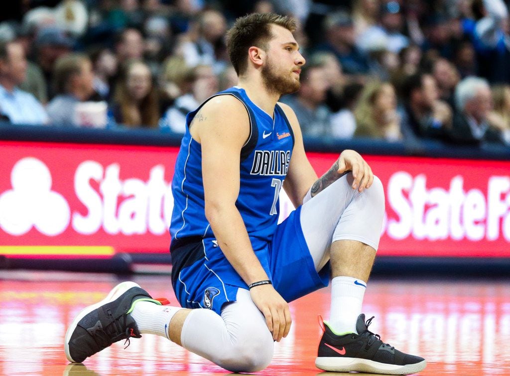 Dallas Mavericks forward Luka Doncic (77) collapse to the floor after getting a ball stolen...