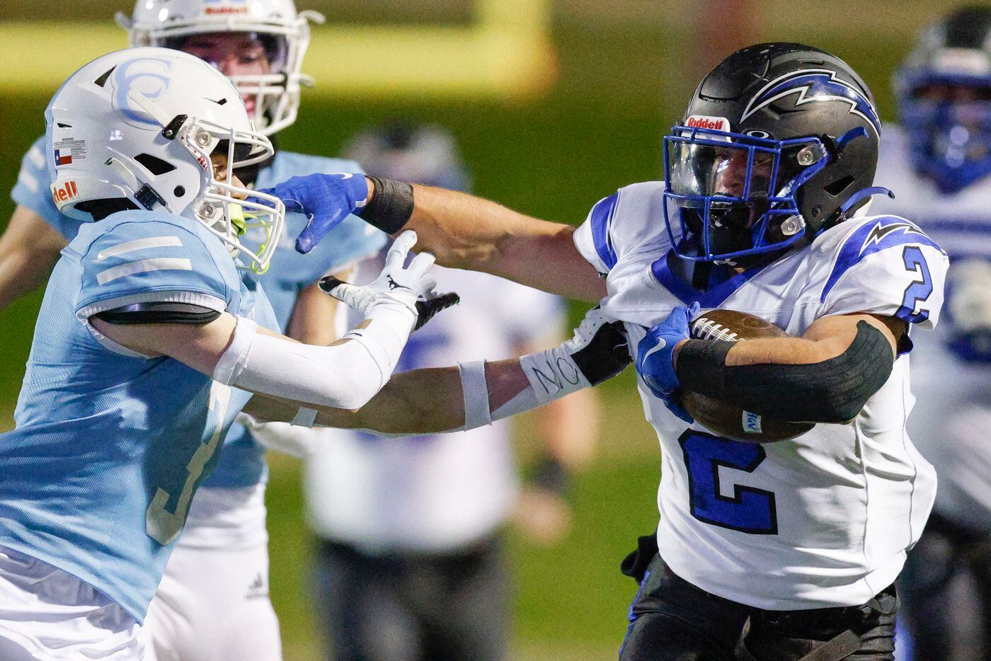 Dallas Christian running back Zachariah Hernandez (2) fights off a tackle from Houston...