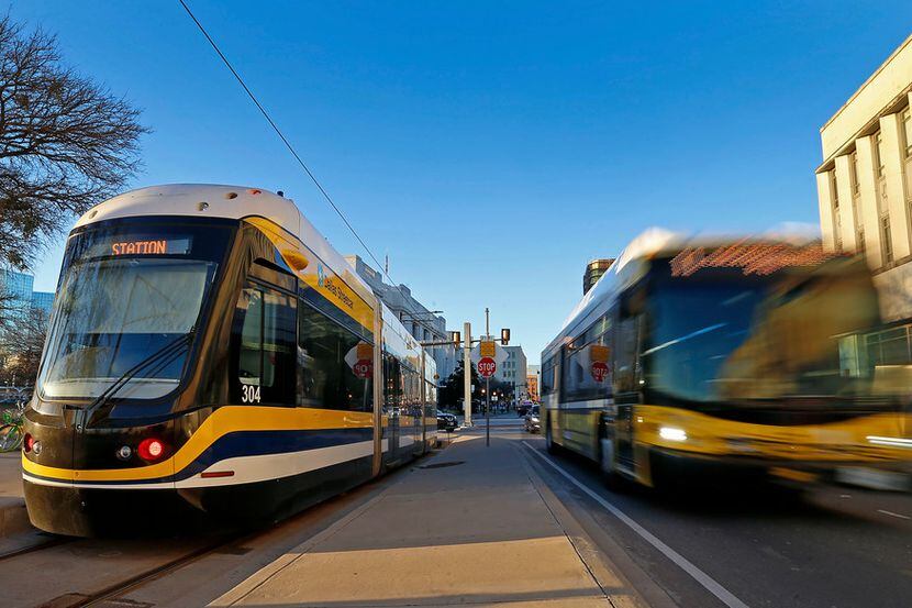 A DART bus passes by the Dallas Streetcar at the Reunion Station stop in Dallas, Tuesday,...