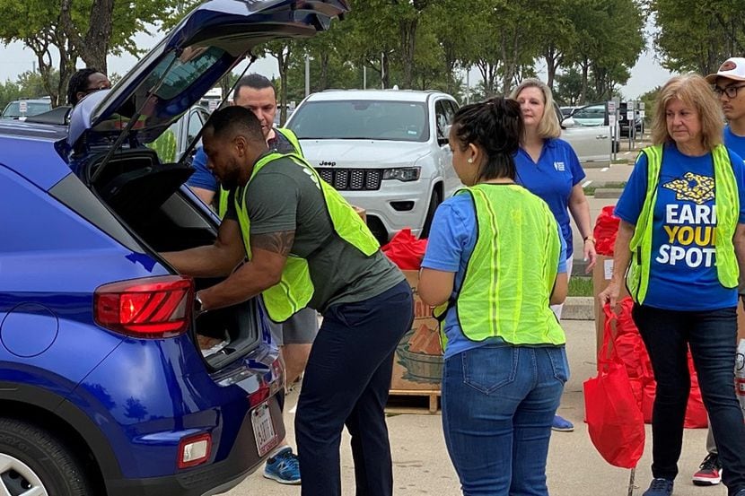 Food bank volunteers pack one of many cars for food distribution throughout North Texas areas.