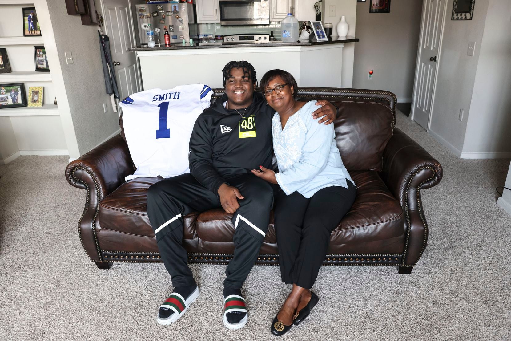 Dallas Cowboys' first-round pick Tyler Smith, 21, and his mother Patricia Smith pose for a...