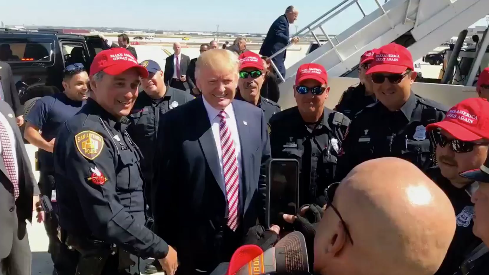 San Antonio police officers posed with Donald Trump after his campaign fundraiser Tuesday....