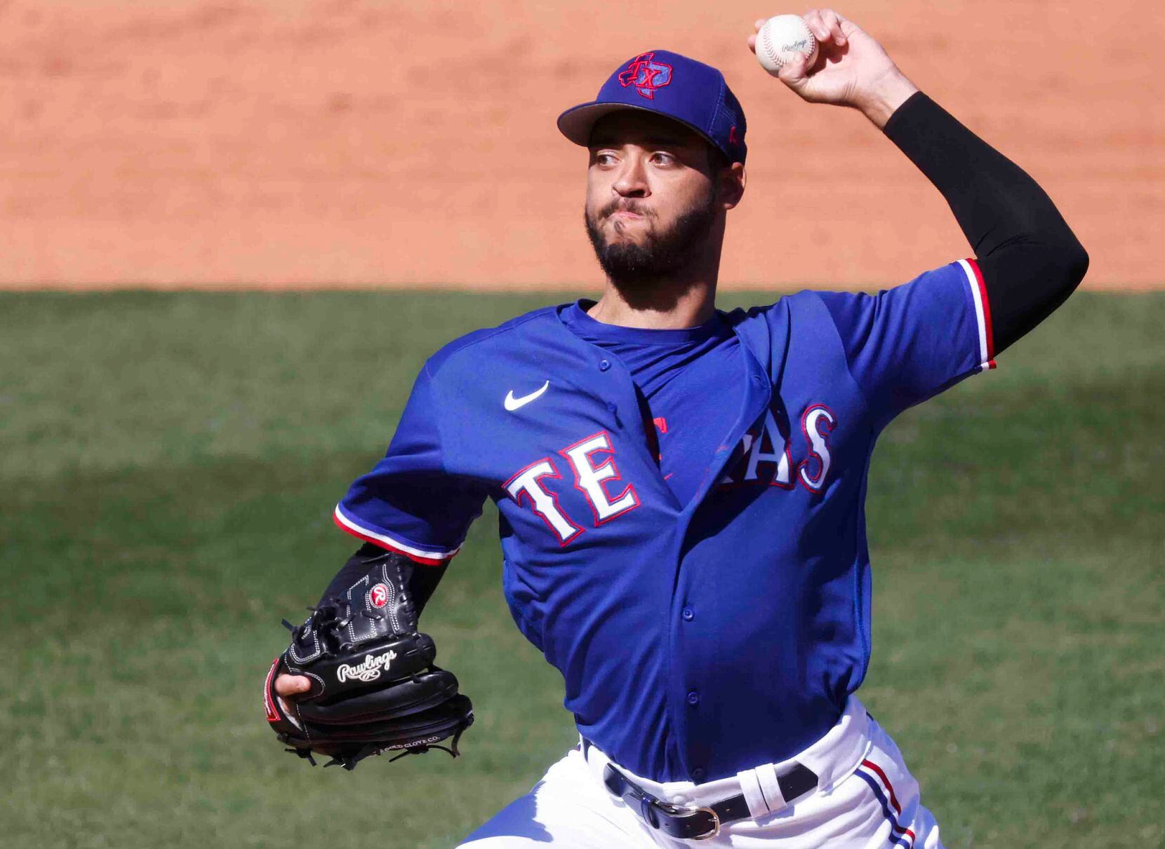 Texas Rangers’ Antoine Kelly throws a pitch during the third inning of a spring training...
