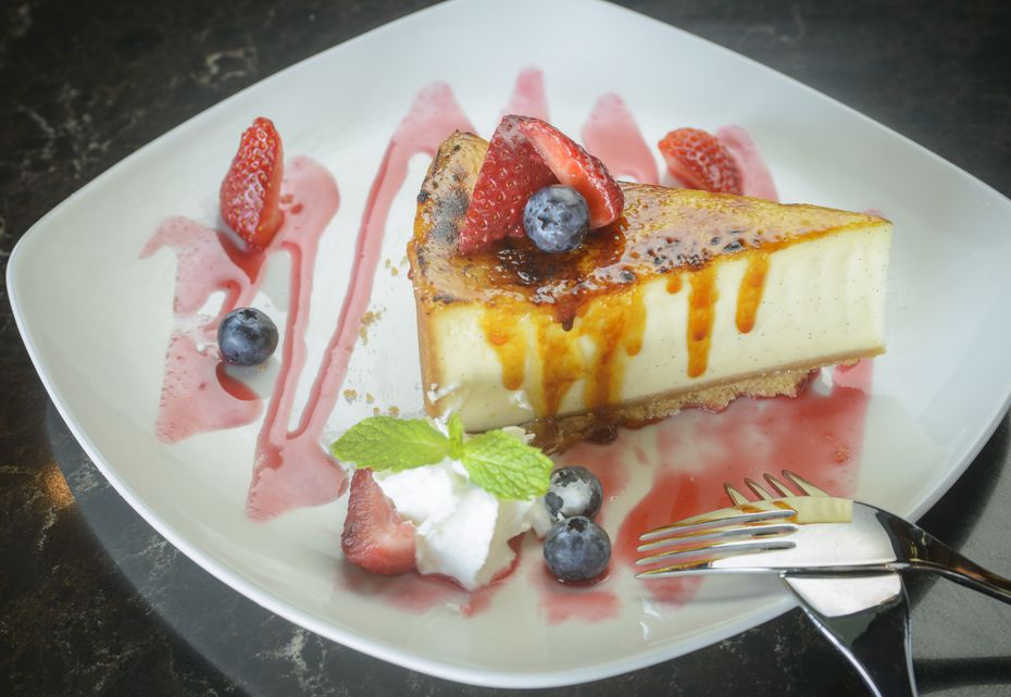 The crème brulée cheesecake is light and fluffy, with a crackly sugared shell on top at...