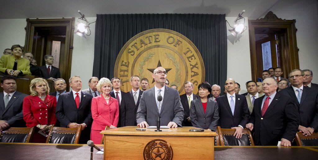  Rep. Dennis Bonnen, center, surrounded by other representatives, announces his plan for a sales tax cut at the Capitol in Austin, Texas, on Wednesday, April 8, 2015. (AP Photo/Austin American-Statesman, Jay Janner) 