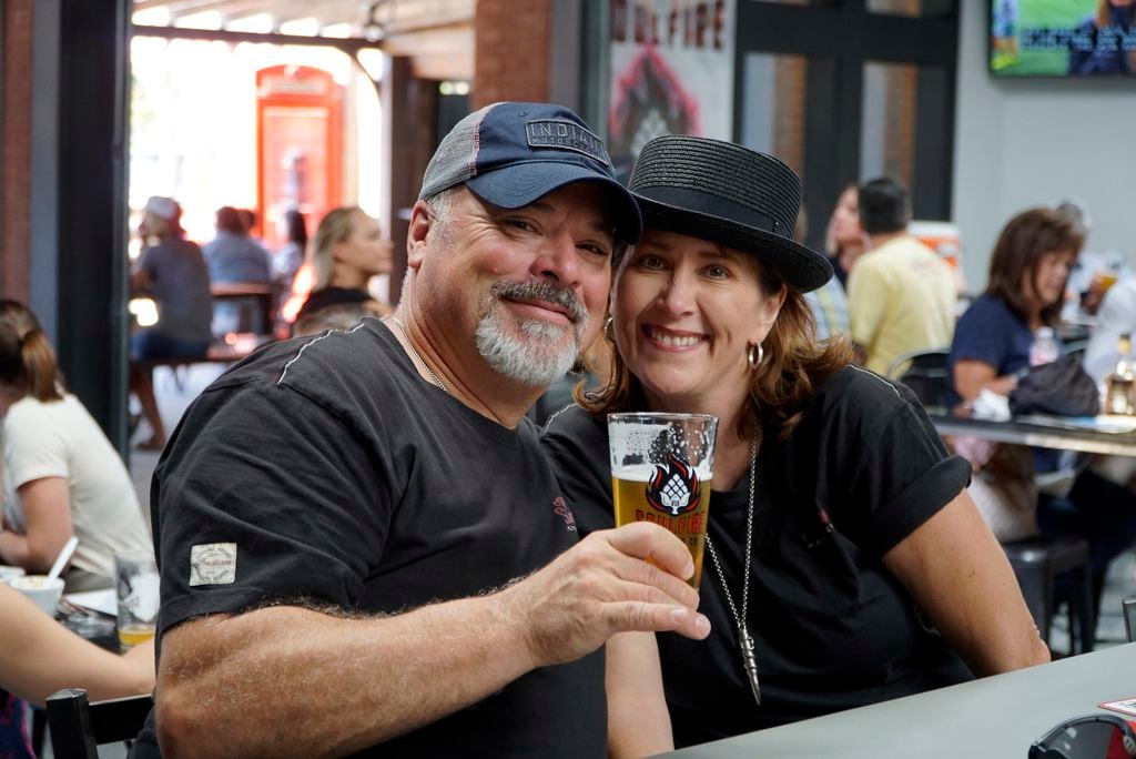 John Brusch and Gina Yates enjoy a cold beverage at Soul Fire Brewing Co.'s grand opening...
