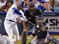 Los Angeles Dodgers' Joey Gallo, second from left, hits a three-run home run while Minnesota...
