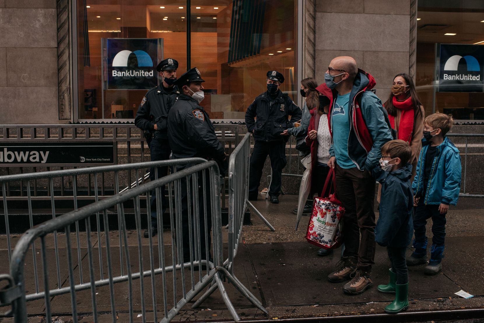A family is stopped at a New York police barricade shortly before the Macy's Thanksgiving Day Parade in New York on Thursday.