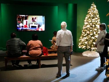 Visitors view a video of the Christmas decorated White House in 2007 during the Holiday in...