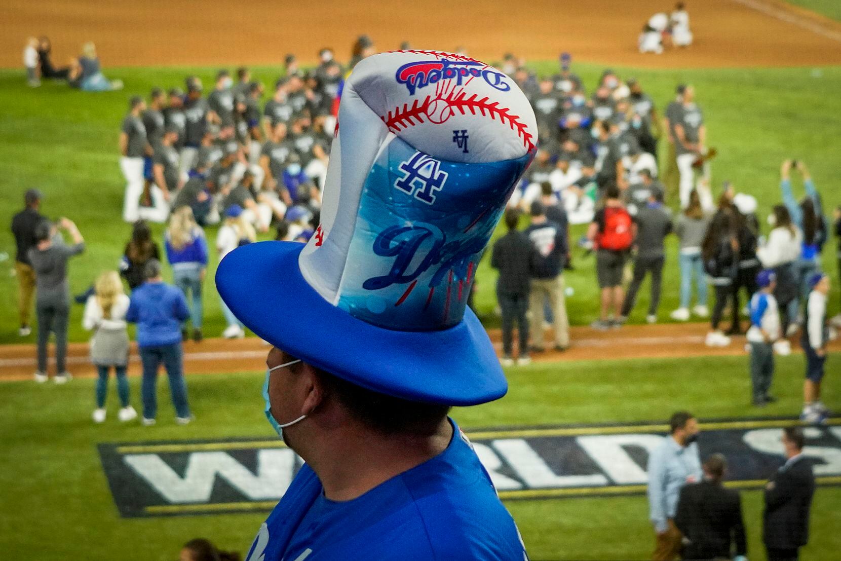 A Los Angeles Dodgers fan watches as players celebrate after defeating the Tampa Bay Rays in...