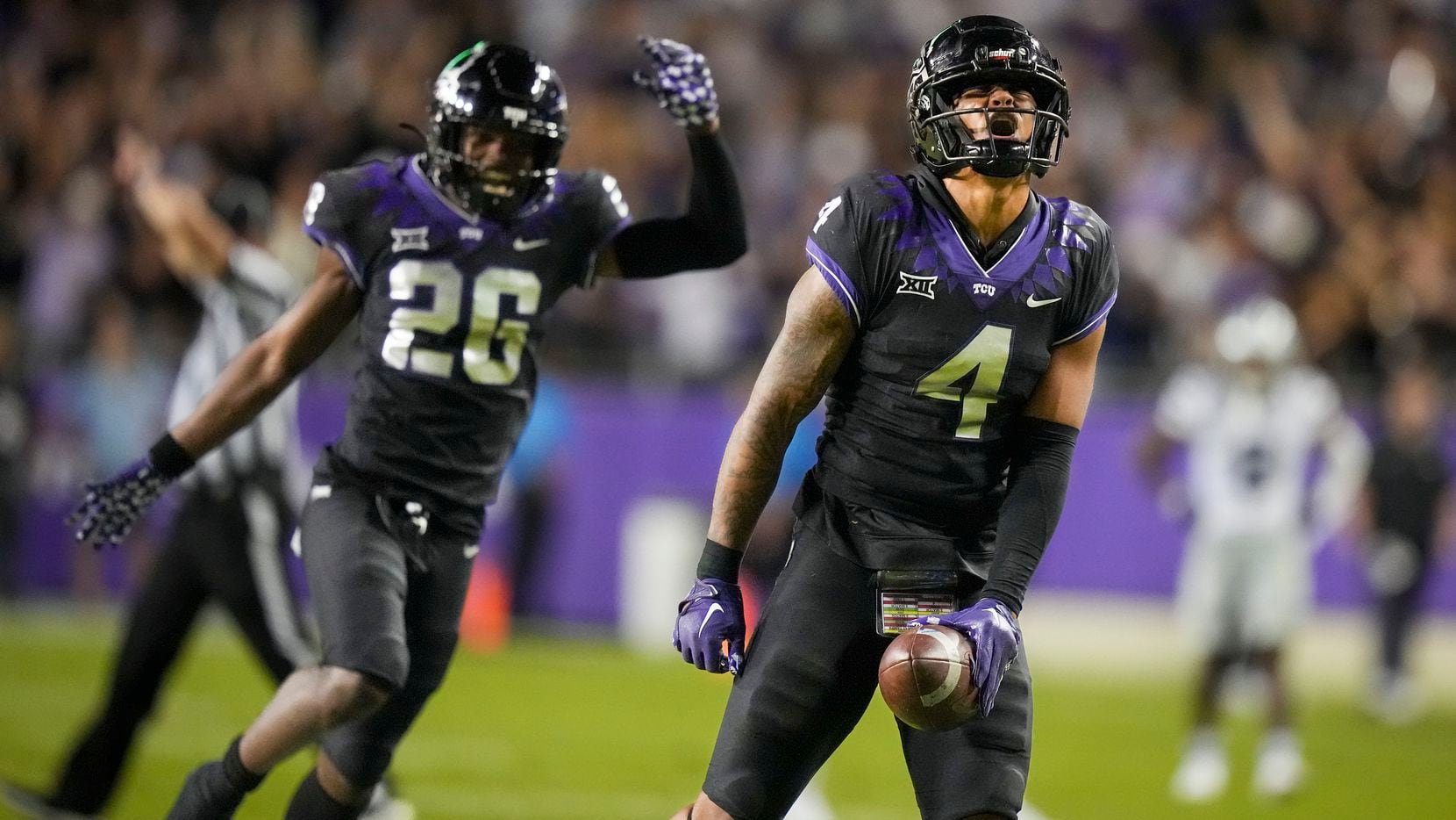 TCU safety Namdi Obiazor (4) celebrates with safety Bud Clark (26) after breaking up a pass...