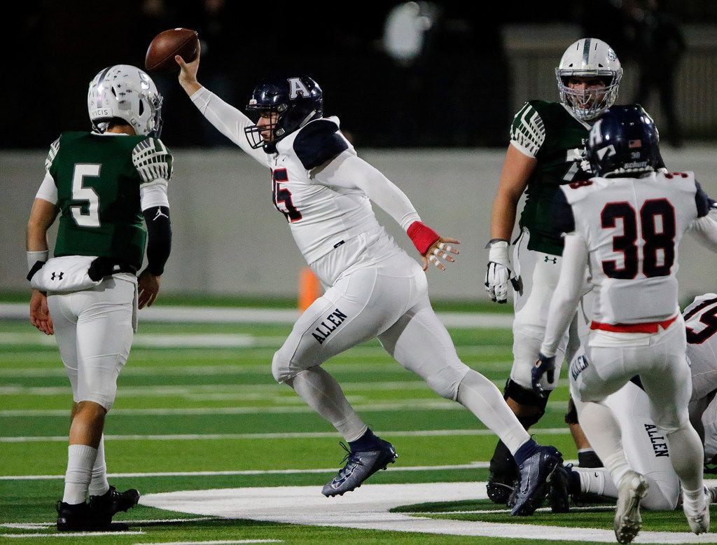 Allen High School defensive lineman Elijah Fisher (95) emerges with a fumble recovery during...