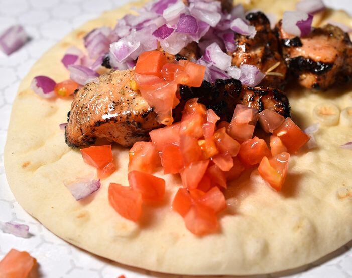 Souvlaki - grilled chicken in a warm pita with tomatoes, onions and yogurt sauce - is served...