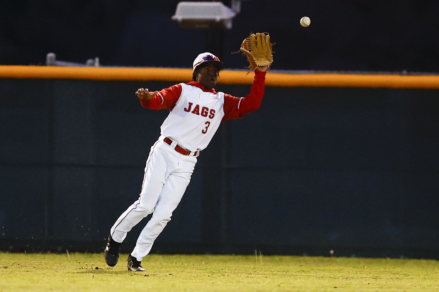Mesquite Horn right fielder Darius Sparks fields a hit by Rockwall-Heath Caleb Hoover during...