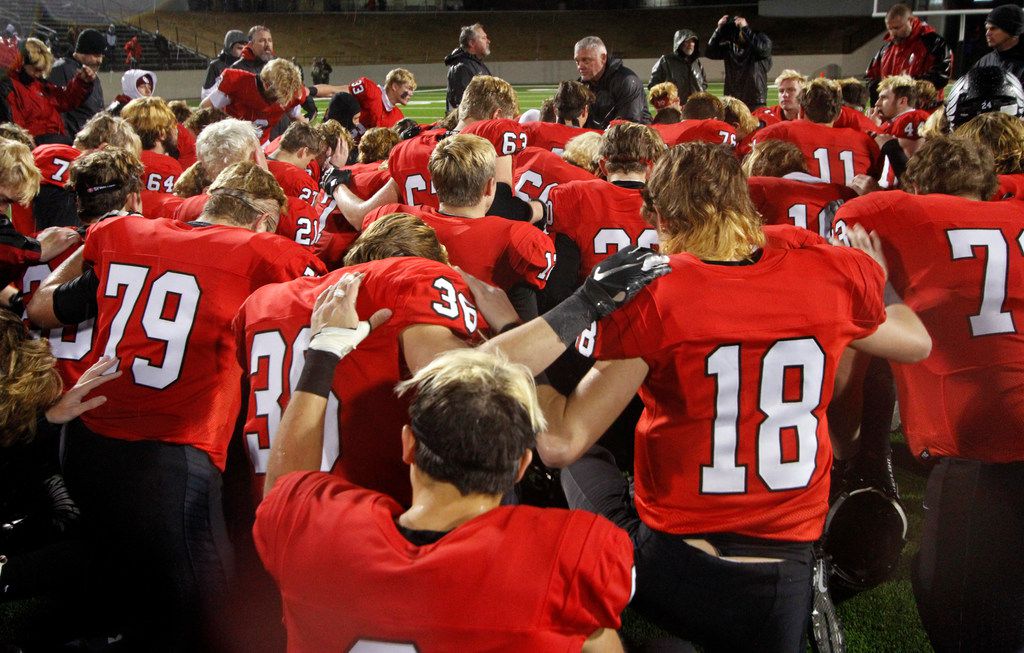 Led by head coach Todd Rodgers, members of the Argyle Eagles emerge from a team prayer...