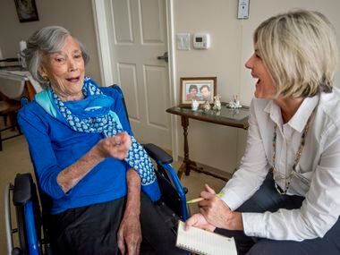 Judith Holbrook, left, a resident at Belmont Village in Dallas, Texas, talks with Tina Lott...