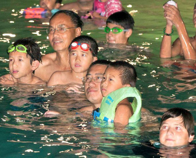 Families watch family movies in the pool at the Frisco Athletic Center Outdoor Aquatic...