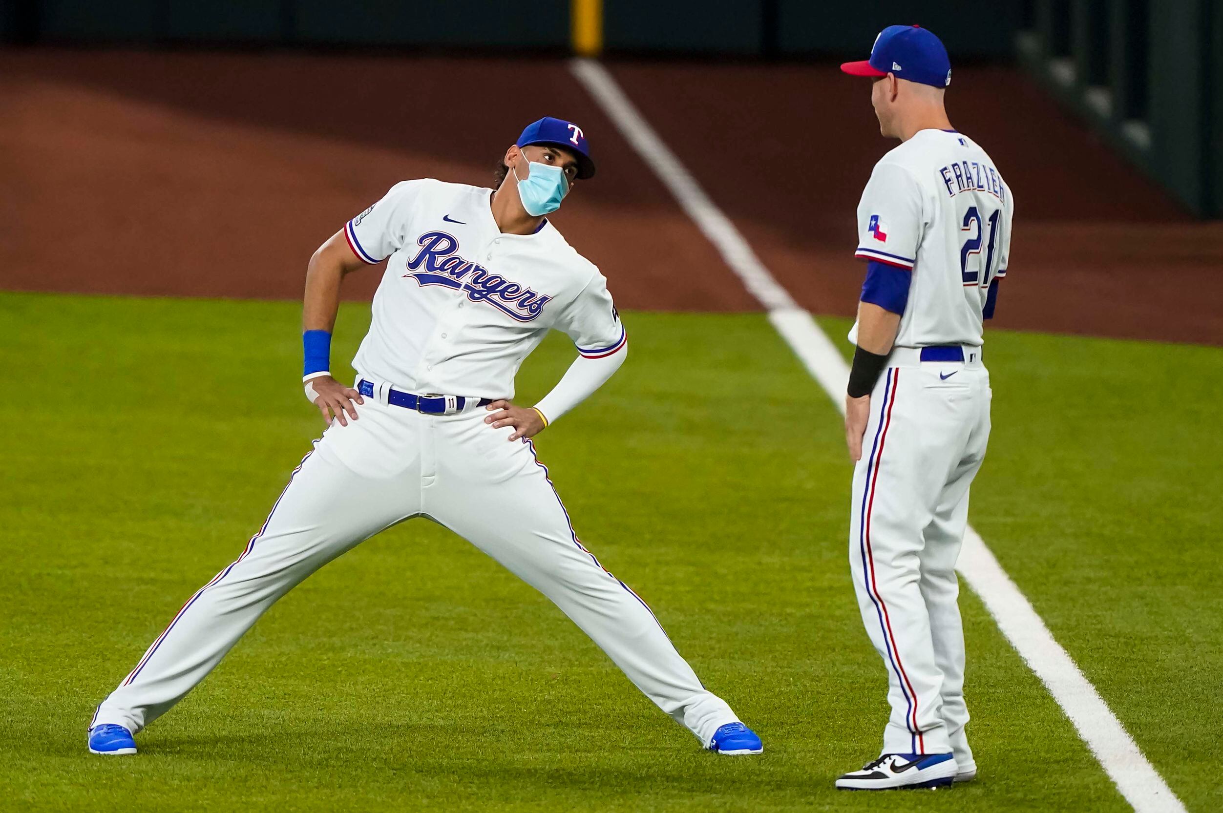 First baseman Ronald Guzman stretches with third baseman Todd Frazier during Texas Rangers...