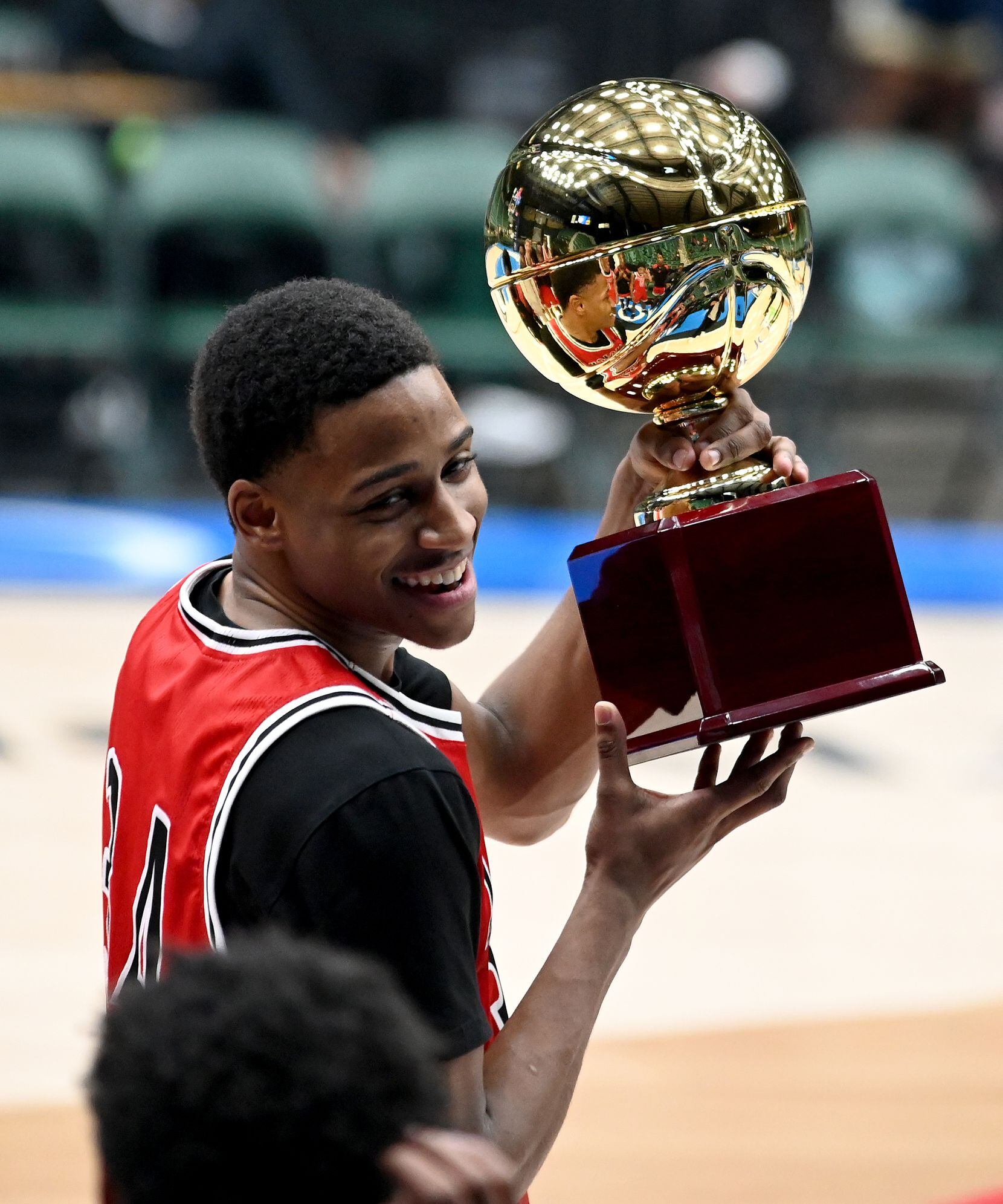 Mansfield Legacy’s Jaxon Miles holds up the championship trophy after Silver championship of the Dallas Mavericks Fall Classic between Keller Central and Mansfield Legacy, Tuesday, Nov. 23, 2021, in Frisco, Texas. (Matt Strasen/Special Contributor)