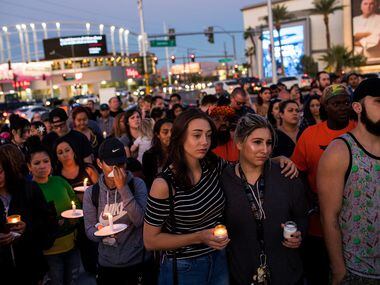 LAS VEGAS, NV - OCTOBER 2: Mourners attend a candlelight vigil at the corner of Sahara...