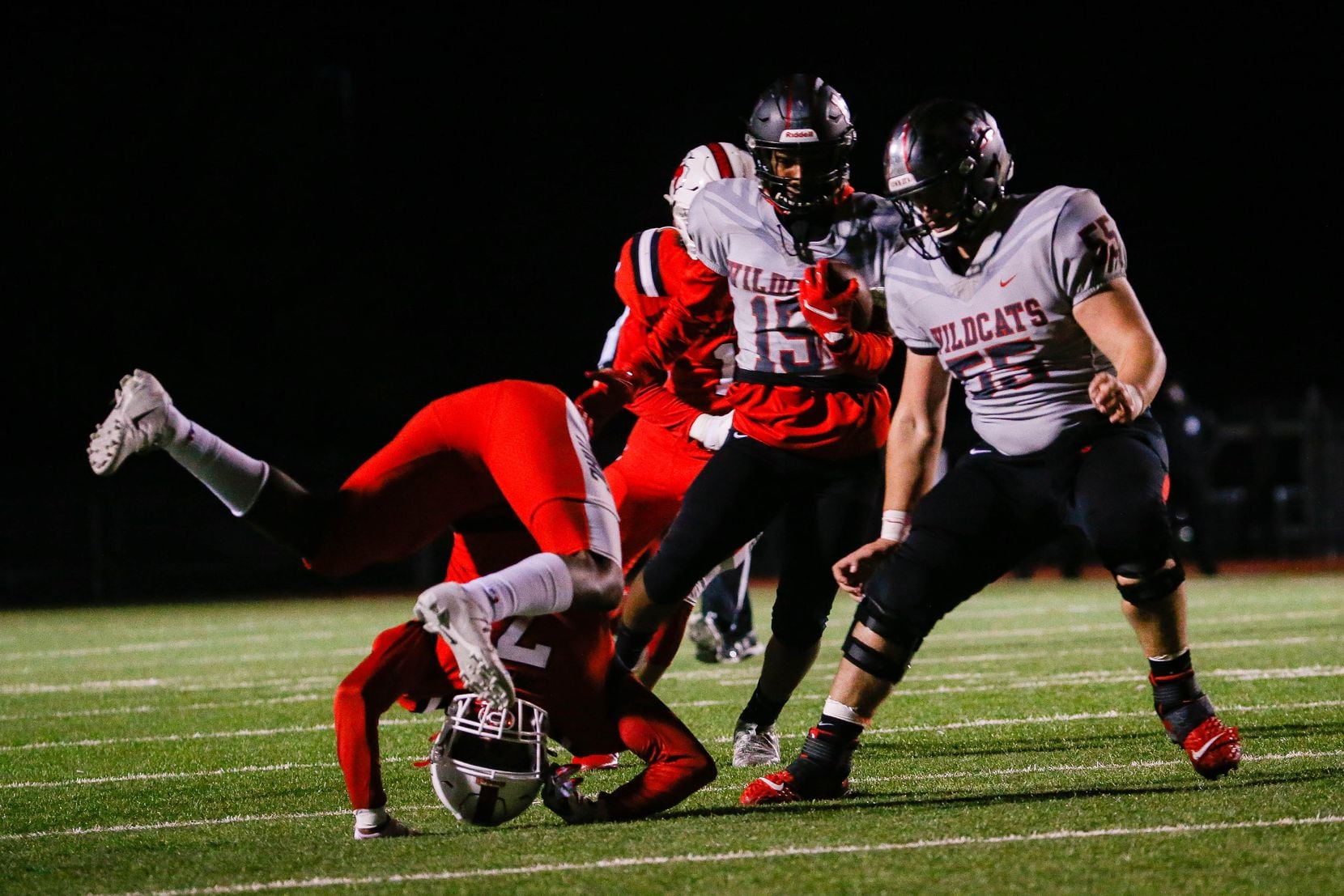 Lake Highlands' DJ Clay (15) avoids a tackle by Irving MacArthur's Jalen Lawrence (7) during...