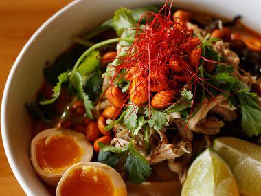 Red Dragon ramen, made with coconut curry broth toppped with woodear mushrooms, shredded...