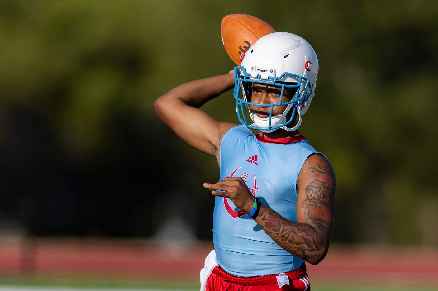 Carter junior quarterback Quaylon Robinson throws during the first practice of the season at...