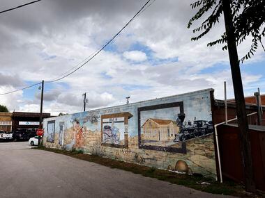 Weathered murals line the wall of a business in downtown Justin, Texas, August 23, 2022.