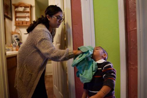 Madai Ochoa, de 17 años ayuda a su hijo Ethan a limpiarse su cara. BEN TORRES/DMN