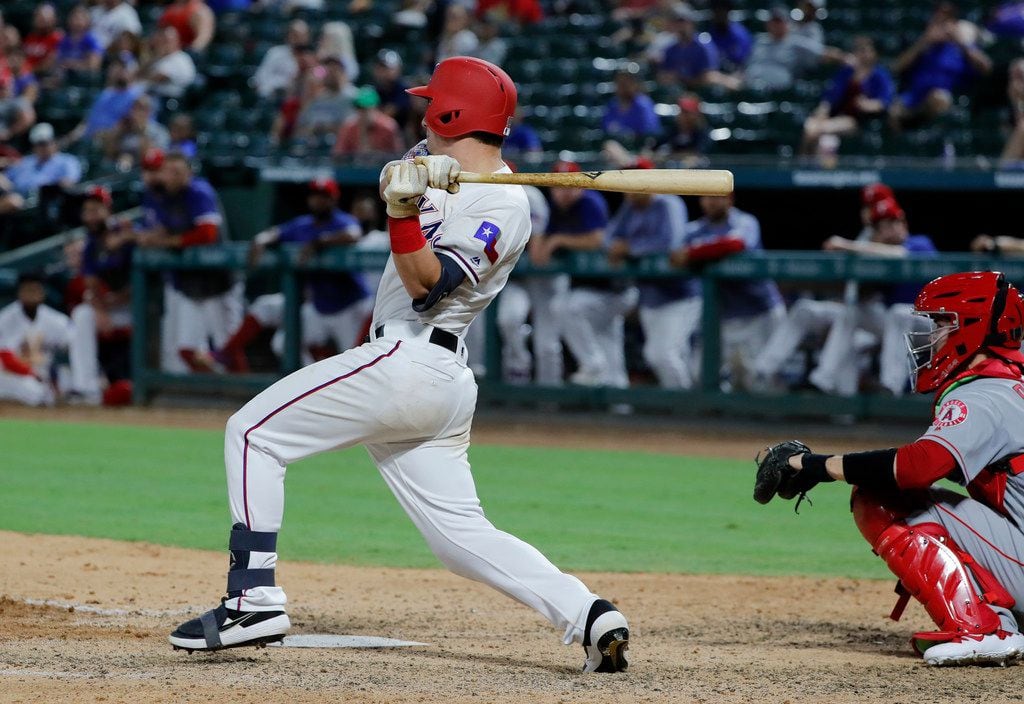 Texas Rangers' Nick Solak follows through on a swing at a pitch from Los Angeles Angels' Ty...