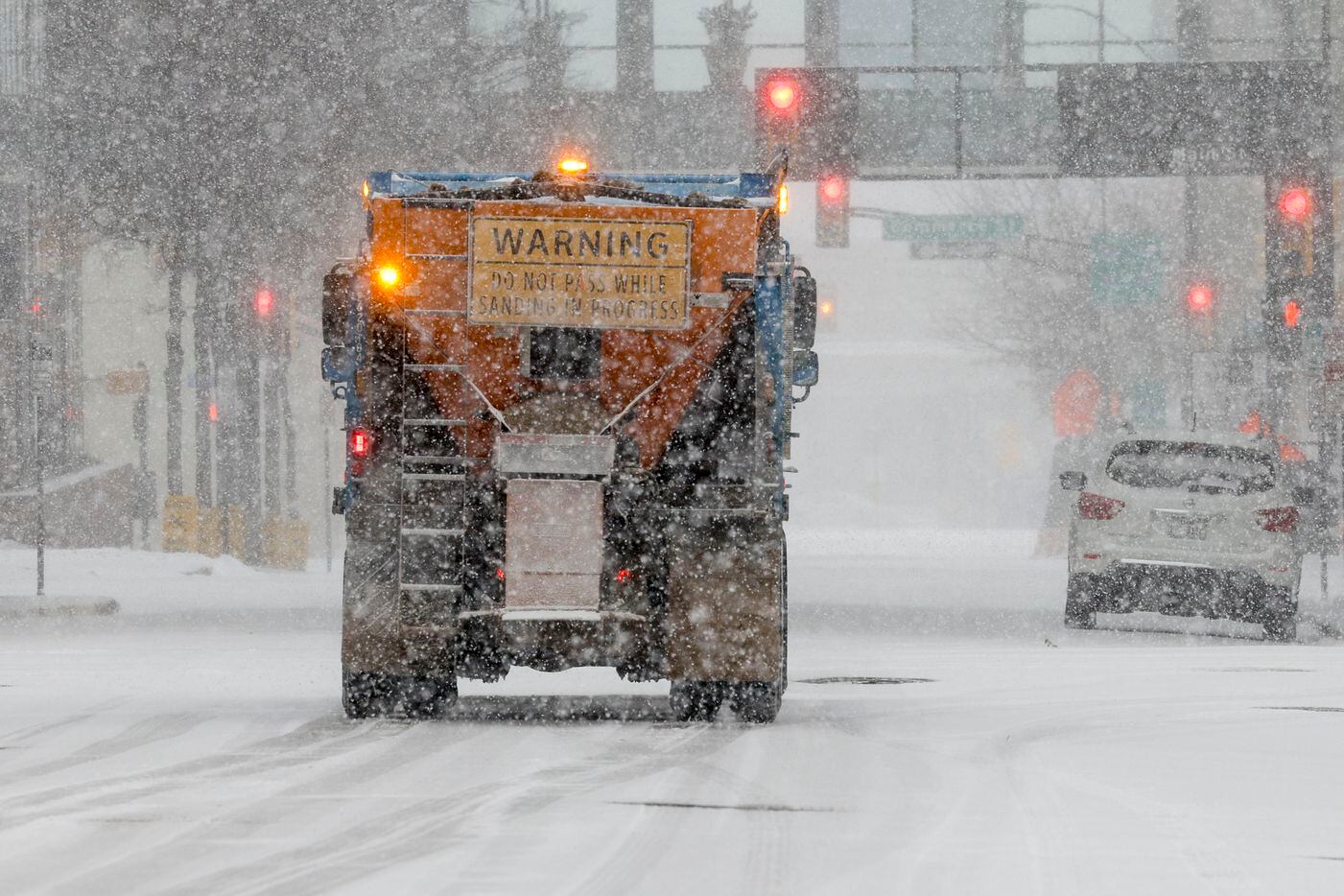 A sanding truck drives through a snow covered downtown Fort Worth on Thursday, Feb. 3, 2022.