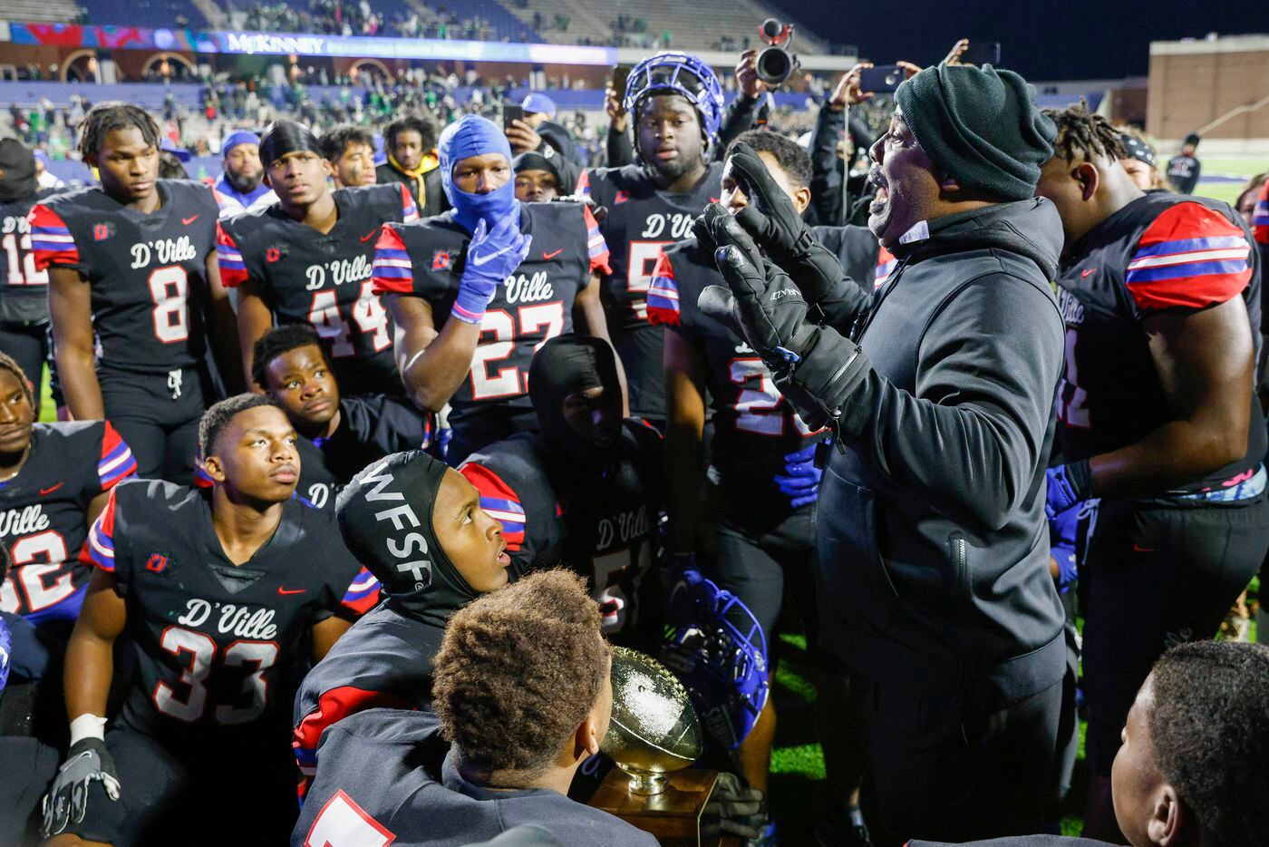 Duncanville head coach Reginald Samples speaks with players after defeating Southlake Carroll in their Class 6A Division I state semifinal playoff game at McKinney ISD Stadium in McKinney, Texas, Saturday, Dec. 11, 2021. Duncanville defeated Southlake Carroll 35-9. (Elias Valverde II/The Dallas Morning News)