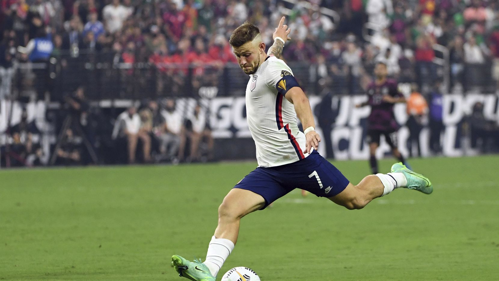 United States forward Paul Arriola (7) kicks the ball against Mexico during the first half...