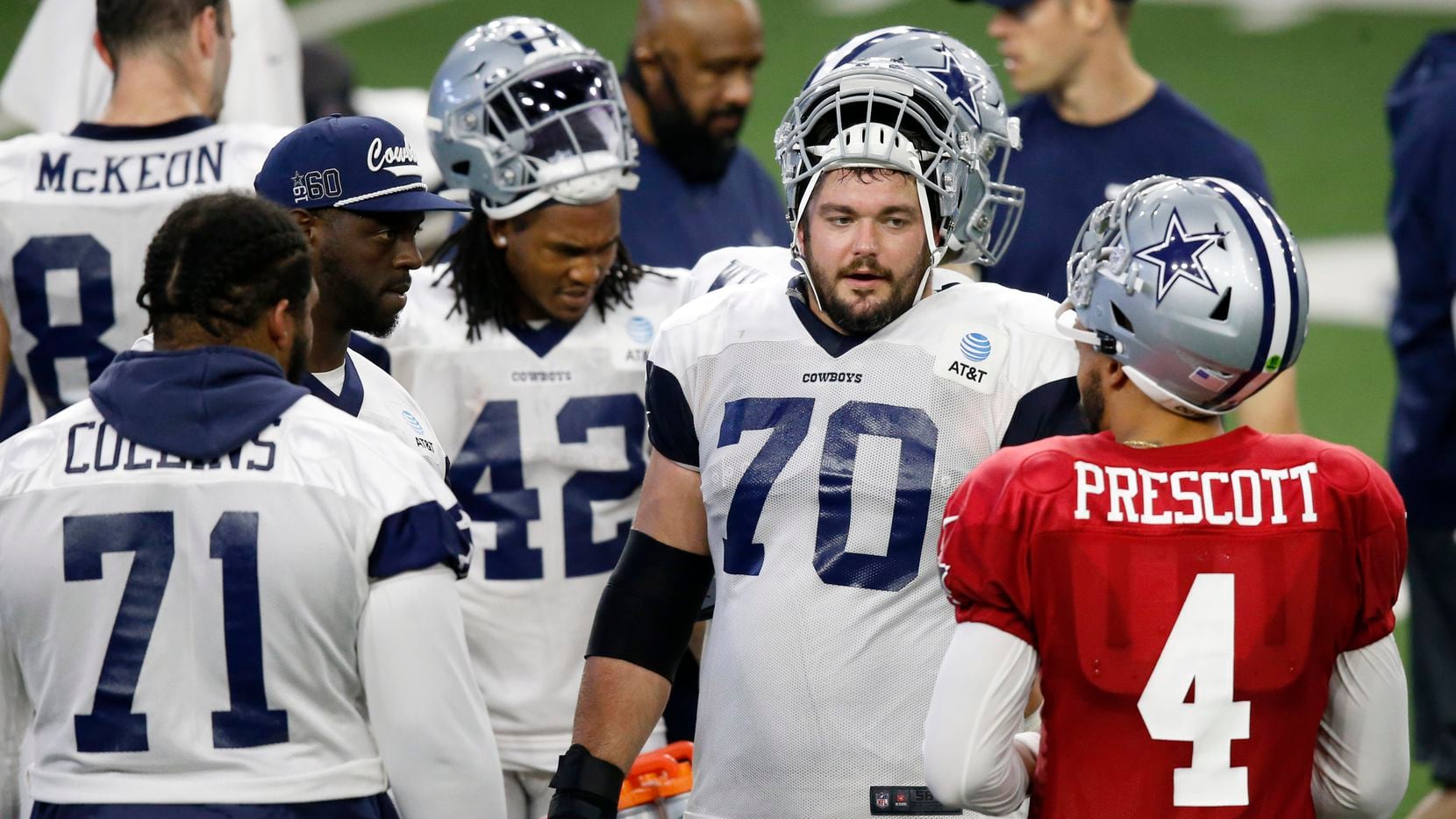 Dallas Cowboys quarterback Dak Prescott (4) talks with Dallas Cowboys guard Zack Martin (70), Dallas Cowboys offensive tackle Cameron Erving (75), and Dallas Cowboys offensive tackle La'el Collins (71) during a break in practice during training camp at the Dallas Cowboys headquarters at The Star in Frisco, Texas on Sunday, August 23, 2020.