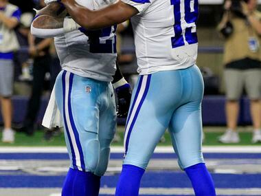 Dallas Cowboys running back Ezekiel Elliott (21) and wide receiver Amari Cooper (19)...