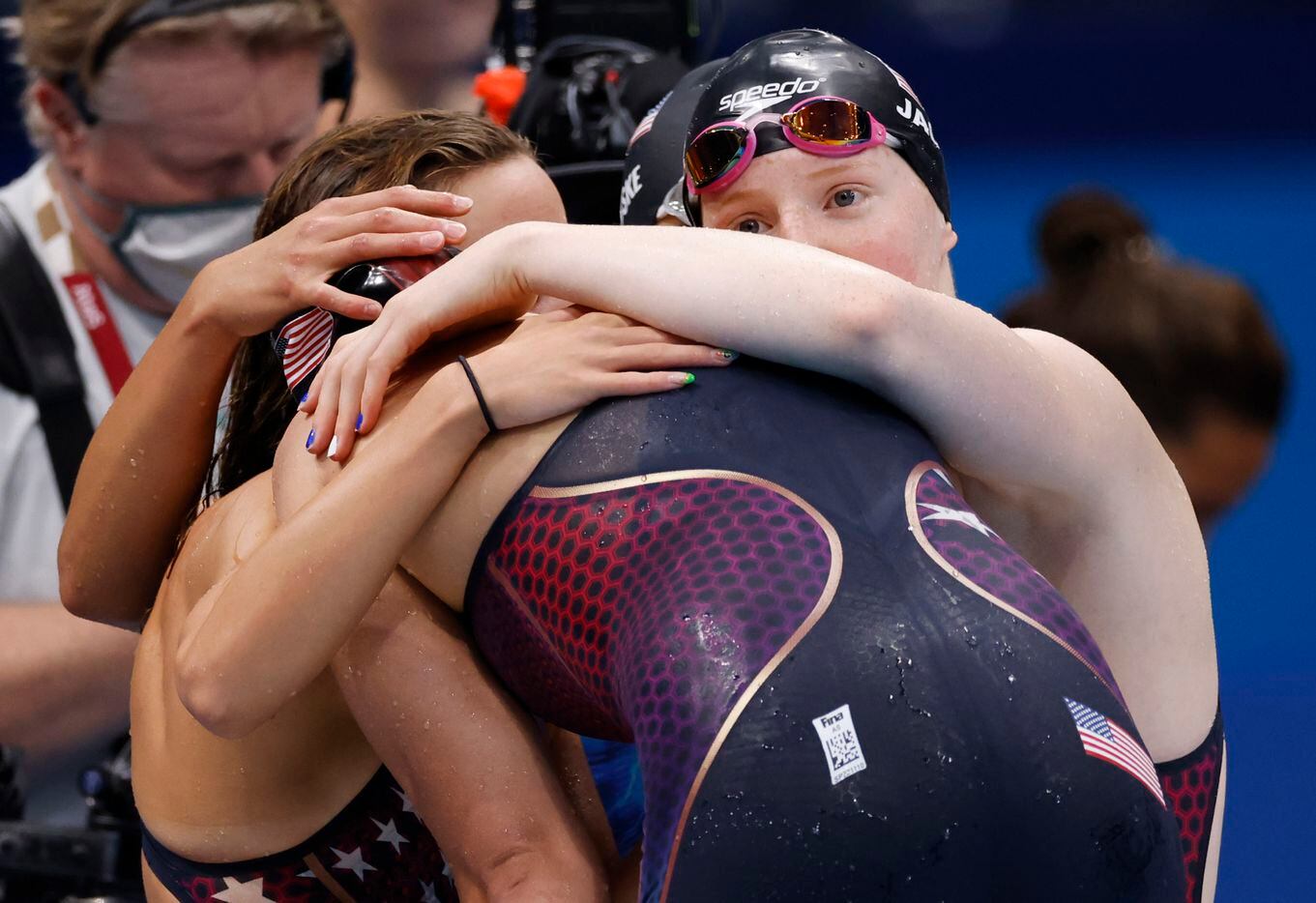 USA’s Regan Smith, Torri Huske, and Lydia Jacoby console an emotional Abbey Weitzeil after...