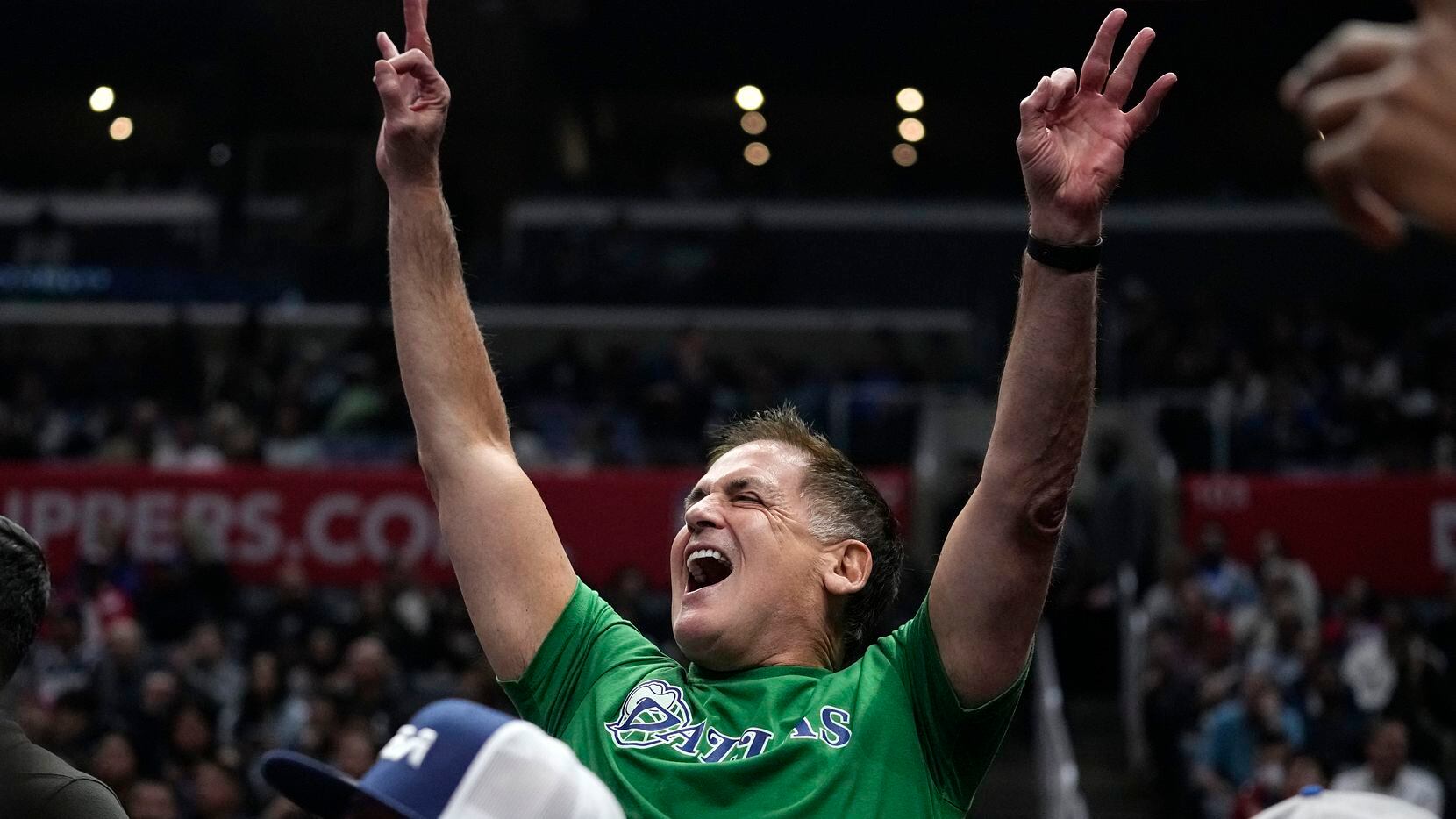 Dallas Mavericks owner Mark Cuban celebrates after guard Kyrie Irving scored during the...