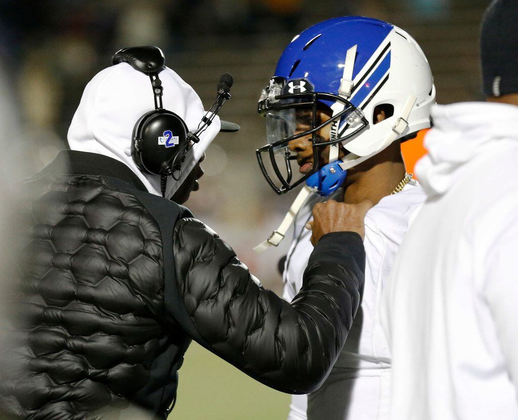 Trinity Christian's offensive coordinator Deion Sanders talks to his son and quarterback Shedeur Sanders (2) after he was thrown out of the game in a game against Austin Regents during the second half of play at the TAPPS Division II State Championship game at Waco Midway's Panther Stadium in Hewitt, Texas on Friday, December 6, 2019. Trinity Christian defeated Austin Regents 48-19. (Vernon Bryant/The Dallas Morning News)